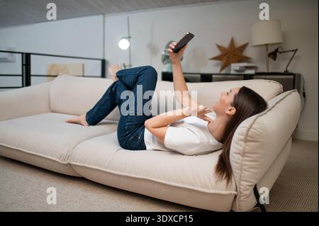 Cheerful pretty young woman making selfie and feeling flirty Stock Photo