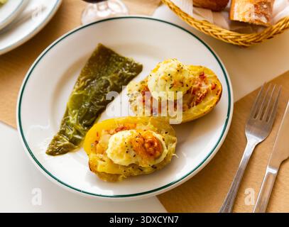 Twice baked potatoes stuffed with meat, jam, cheese and egg Stock Photo