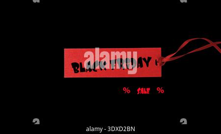 Blank dark red paper label with ribbon isolated on white background with copy space. Price or gift tag. Stock Photo