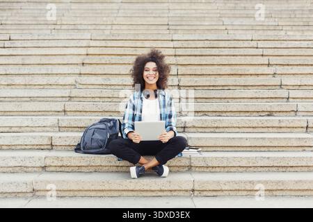 A Young Woman Sits on Steps Stock Photo