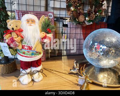 Edremit, Turkey - December 02, 2025: Santa Claus figurine with teddy bear and Christmas decorations in a shop, showcasing a joyful holiday atmosphere Stock Photo