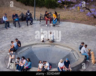 Mexico City Mexico - February 19 2022: Elevated View of People Sitting Around a Fountain at Alameda Park in Mexico City Stock Photo