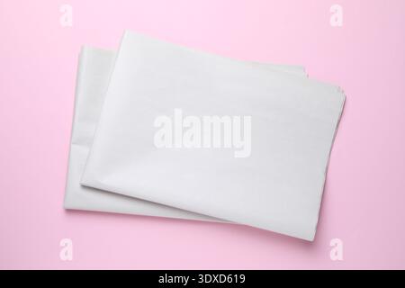 Newspapers on pink background, top view. Mockup for design Stock Photo