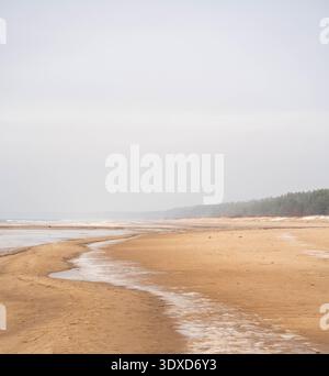 Wide sandy Baltic Sea beach with shallow water patterns in Lilaste, Latvia Stock Photo