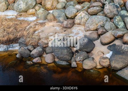 Natural stone and sand textures with water on the Baltic Sea coast in Lilaste, Latvia Stock Photo