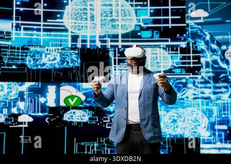 African American engineer working on machine learning with virtual reality tools, implementing models and intelligent systems via neural networks. Programming and cloud computing. Stock Photo