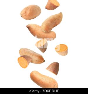 Sweet potatoes falling against white background. Whole and sliced Stock Photo