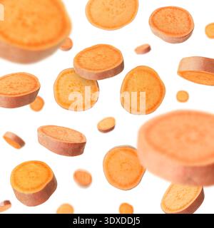 Sweet potato pieces falling against white background Stock Photo