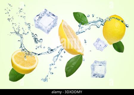 Fresh lemons, splashing water and ice cubes in air against light green background Stock Photo