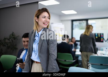 Business meeting takes place in an office with professionals discussing and collaborating on projects during the day Stock Photo