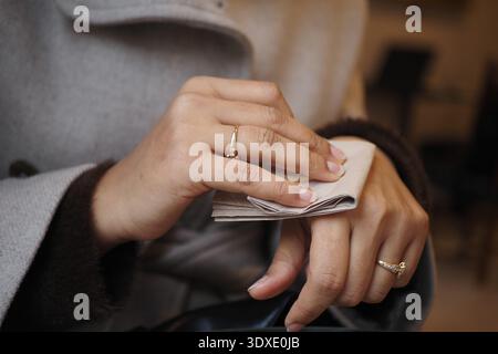 Woman with paper in cozy indoor social setting Stock Photo