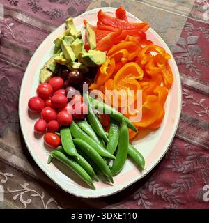 A platter of cut vegetables is on the table. Stock Photo