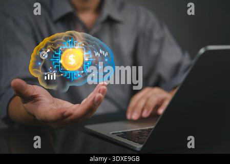 Businessman hand holding virtual brain with dollar money chip using laptop computer. AI technology concept for financial investment growth. Smart fint Stock Photo