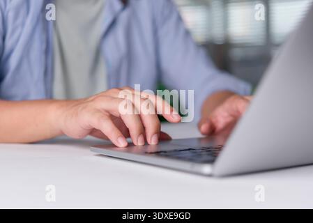 Person using touchpad laptop browsing web content website. Student learning education course online research information. Modern programmer coding sof Stock Photo