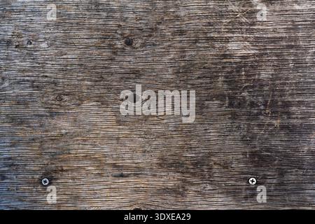 Weathered Grey Wood Texture with Natural Grain and Industrial Screw Details Stock Photo