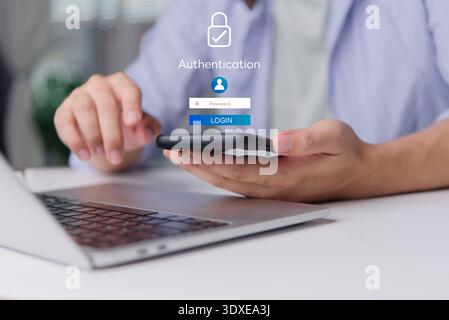 User secure login authentication password. Cybersecurity concept data protection. Man hand using smartphone laptop desk. Virtual screen padlock icon i Stock Photo