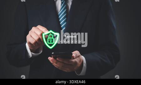 Businessman hand holding smartphone secure payment. Online banking security data protection technology. shield padlock password authentication. Cybers Stock Photo