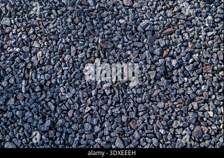Small stones wall used for background texture.Small Rock Textured background. Seamless texture of gravel. crushed granite texture. Stock Photo