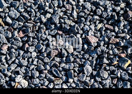 Small stones wall used for background texture.Small Rock Textured background. Seamless texture of gravel. crushed granite texture. Stock Photo