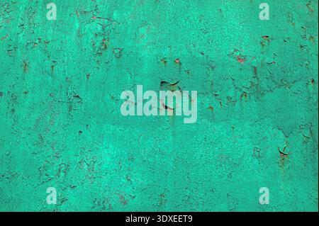 Green plastered concrete wall.Green patina (verdigris) on copper sheet metal.Gloss green enamel paint blistering and peeling off a galvanised iron gat Stock Photo