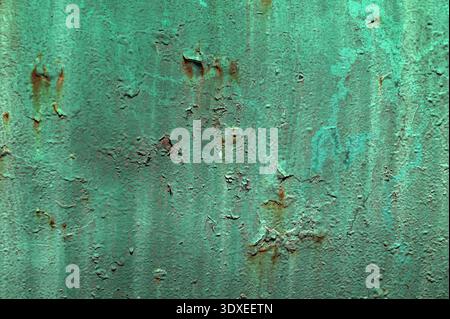 Green plastered concrete wall.Green patina (verdigris) on copper sheet metal.Gloss green enamel paint blistering and peeling off a galvanised iron gat Stock Photo