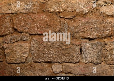 Background of stone wall texture photo.pattern gray color of modern style design decorative uneven cracked real stone wall surface with cement. Stock Photo