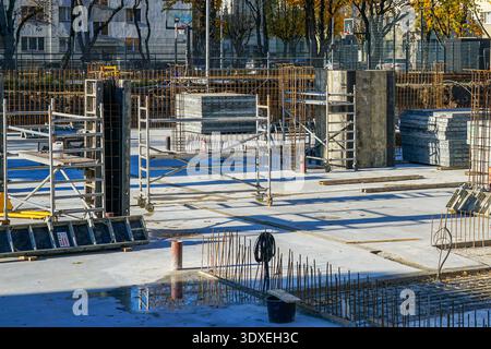 Urban Construction Site with Concrete Slabs Rebar Columns and Scaffolding Stock Photo