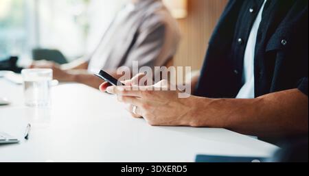 Person, hands and typing with phone for communication, social media or schedule on office desk. Businessman, texting and reading with mobile Stock Photo