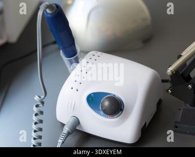 Electric manicure machine on table. Drill for manicure Stock Photo