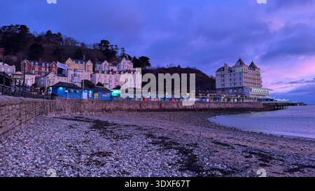 Llandudno North Shore at sunrise, view taken from the beach looking towards the pier and the Grand Hotel, tourism, travel, historic Wales Stock Photo