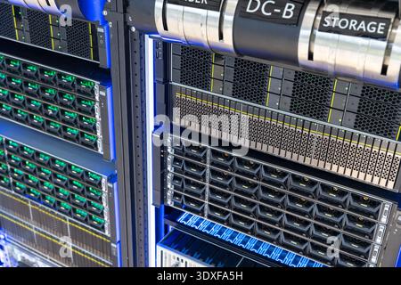 High performance data center server racks and enterprise storage array with LED status lights, network infrastructure hardware close up Stock Photo