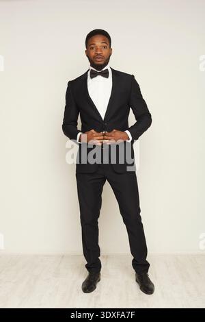 Man in Formal Suit Stands Confidently for a Portrait Photo in a Studio Setting Stock Photo