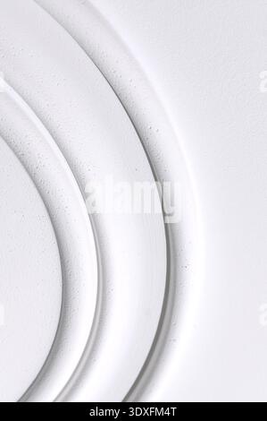 Decorative item made of white plaster on ceiling close-up. Relief stucco interior Stock Photo