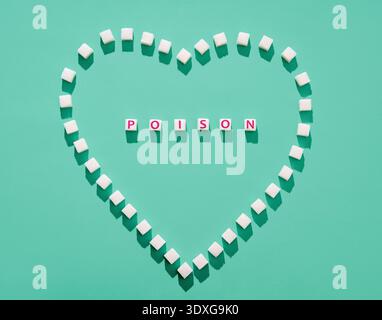 Sugar cubes forming heart with word poison inside,  danger of excessive sugar consumption concept Stock Photo