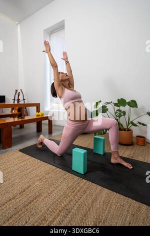 Pregnant Woman Practicing Supported Lunge Yoga Indoors Stock Photo