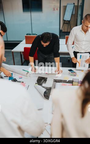 Business team collaborates on a design project at a bright office workshop Stock Photo