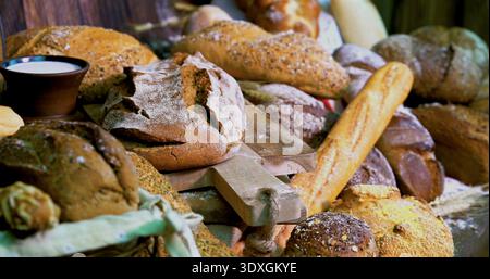 Fresh bread displayed at a local market during the morning hours, inviting customers to explore various types of baked goods Stock Photo