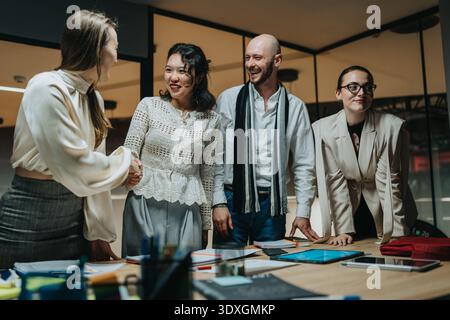 Group of professionals greeting each other in an office during a collaborative meeting Stock Photo