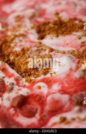A macro, full-frame texture shot of strawberry cheesecake ice cream Stock Photo