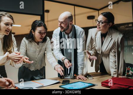 Business team brainstorms ideas during a collaborative meeting around a table Stock Photo