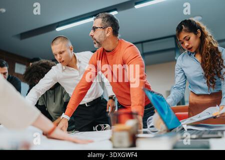 Diverse group of professionals collaborating around a table in a modern office Stock Photo