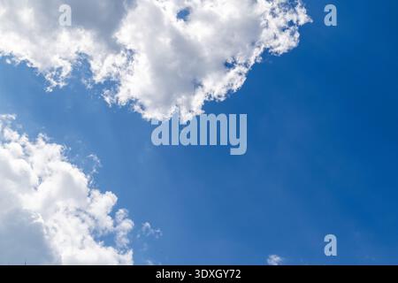 White cloud formation over a deep blue sky, peaceful cloudscape with copy space, Province of Luxembourg, Wallonia, Belgium. Stock Photo