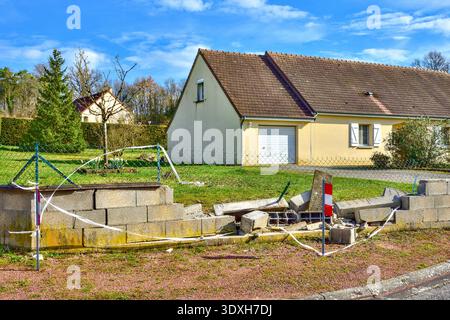 Damaged breeze block wall at edge of bungalow garden - central France. Stock Photo