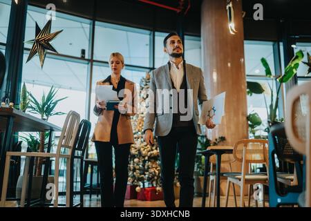 Business partners review documents in a modern office during the holidays season Stock Photo