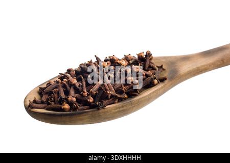 Cloves on wooden scoop, isolated on white background. Stock Photo
