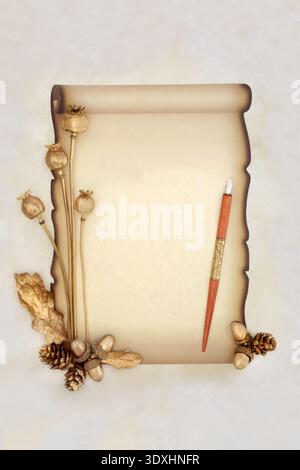 Paper scroll on parchment with calligraphy pen, gold flora. Vintage old fashioned faded document blank for love letter, invitation, message. Stock Photo