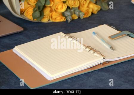 Year Planning Concept with Open Spiral Notebook, Pen, Coffee Cup on Blue Desk Stock Photo