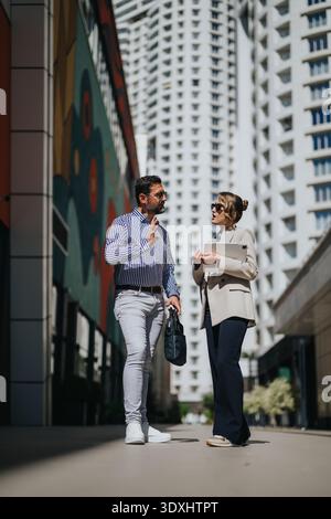 Business colleagues having a professional discussion outside in an urban office district Stock Photo