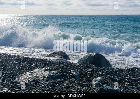 Beautiful seascape with waves breaking on the rocky shore. Stock Photo