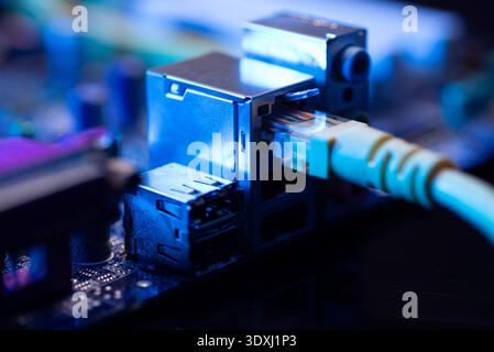 Fiber optic cables connected to optical ports and network cables connected to internet ports Stock Photo